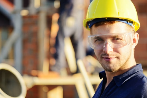 Male construction worker smiling at a building site