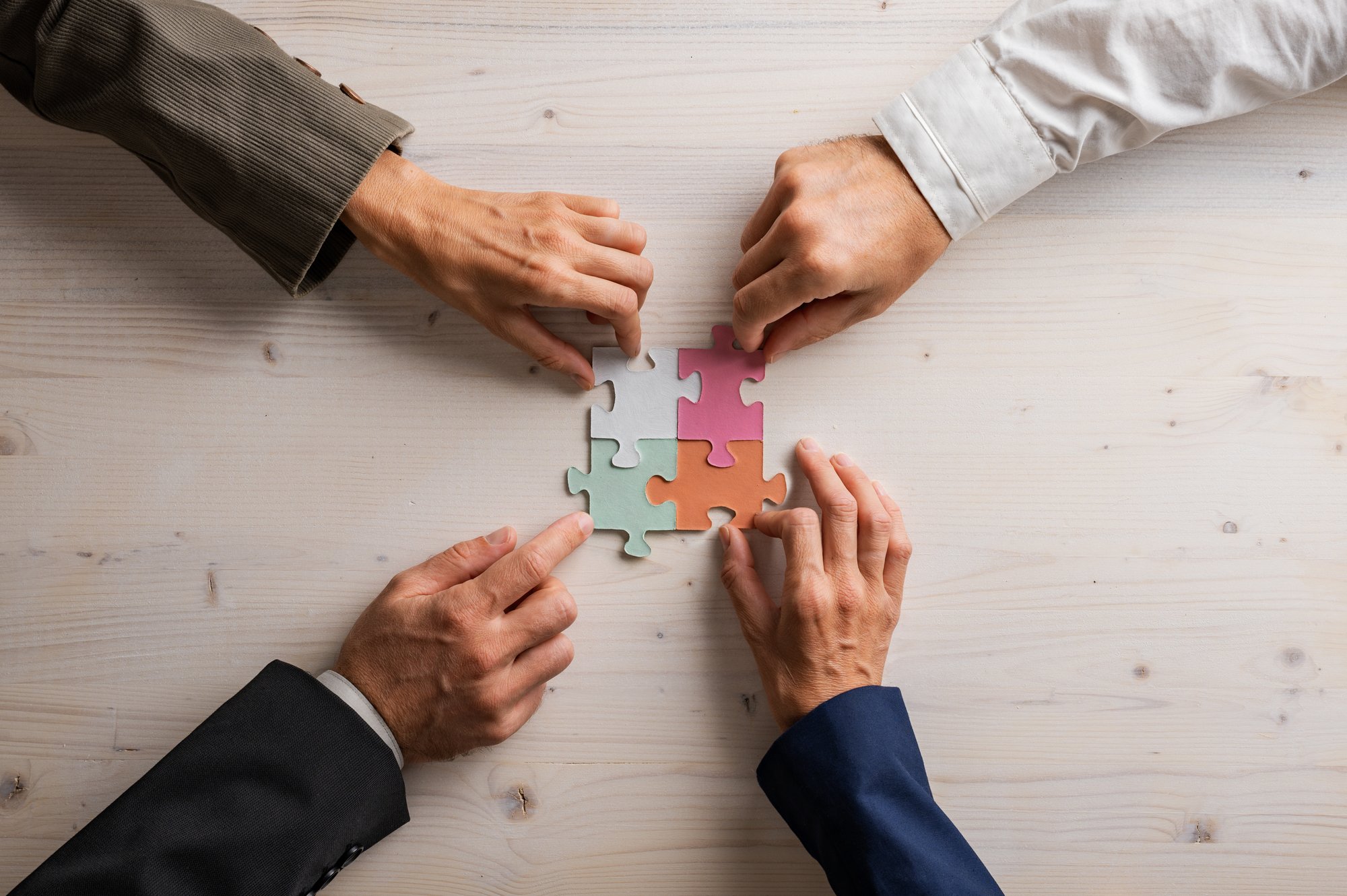 four-people-connecting-colorful-puzzle-pieces-toge-2026-03-19-01-50-51-utc